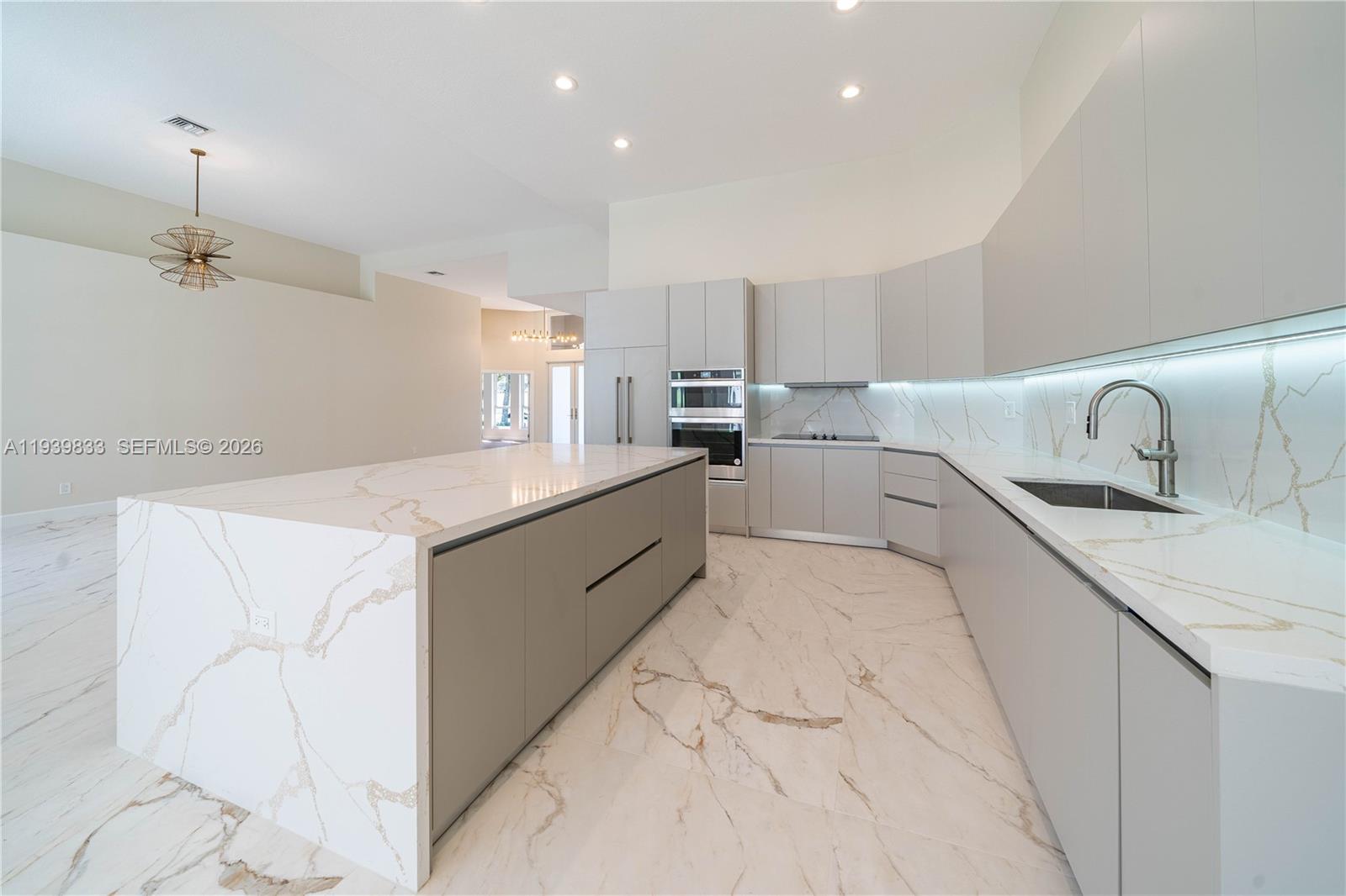 8041 Bermuda Point Lane Davie, FL 33328 - Photo 22 of 60 a large white kitchen with cabinets