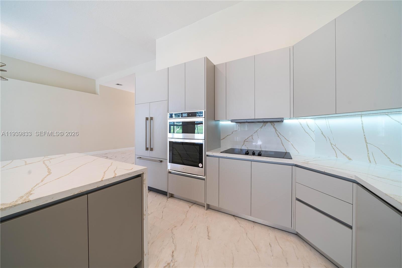8041 Bermuda Point Lane Davie, FL 33328 - Photo 23 of 60 a kitchen with granite countertop white cabinets and white stainless steel appliances