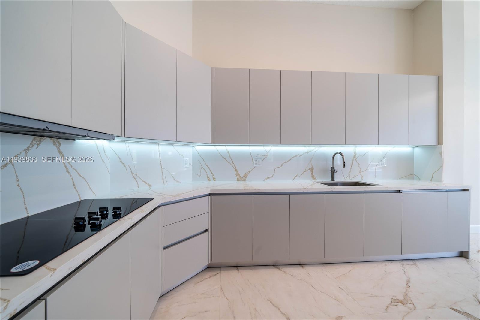 8041 Bermuda Point Lane Davie, FL 33328 - Photo 24 of 60 a kitchen with a sink and cabinets