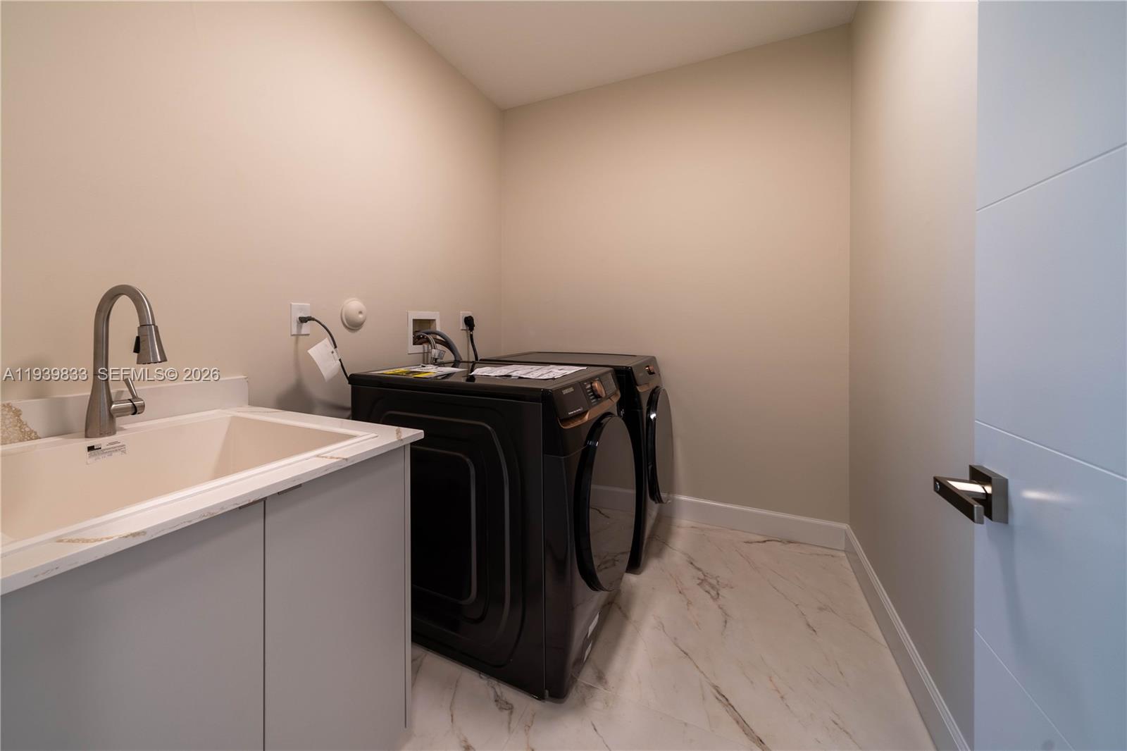 8041 Bermuda Point Lane Davie, FL 33328 - Photo 27 of 60 a utility room with dryer and washer