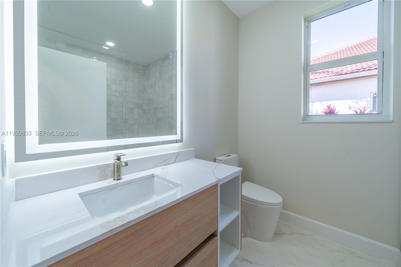 8041 Bermuda Point Lane Davie, FL 33328 - Photo 29 of 60 a bathroom with a sink and a toilet
