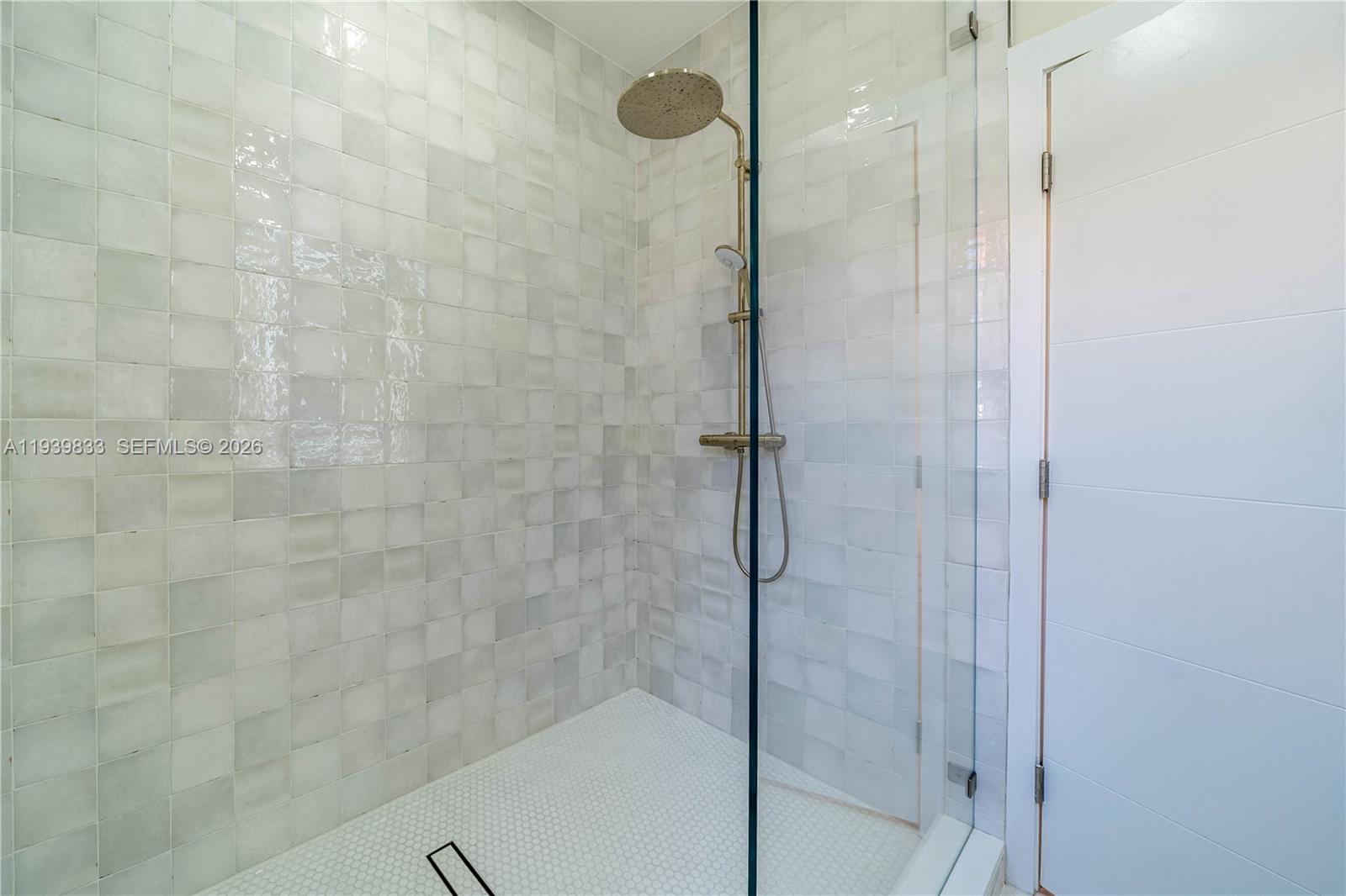 8041 Bermuda Point Lane Davie, FL 33328 - Photo 30 of 60 a bathroom with a glass shower door