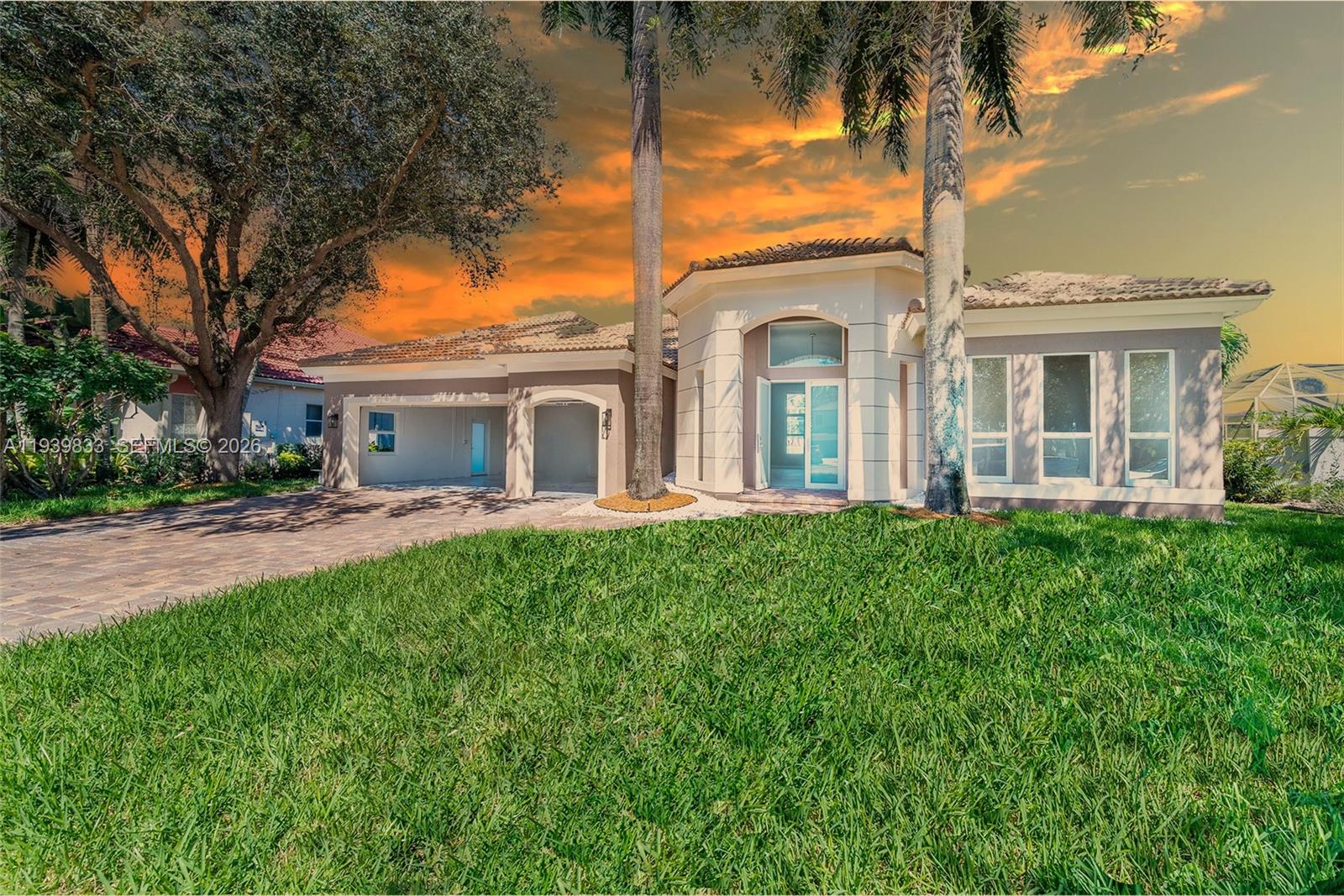 8041 Bermuda Point Lane Davie, FL 33328 - Photo 3 of 60 a front view of a house with yard and green space