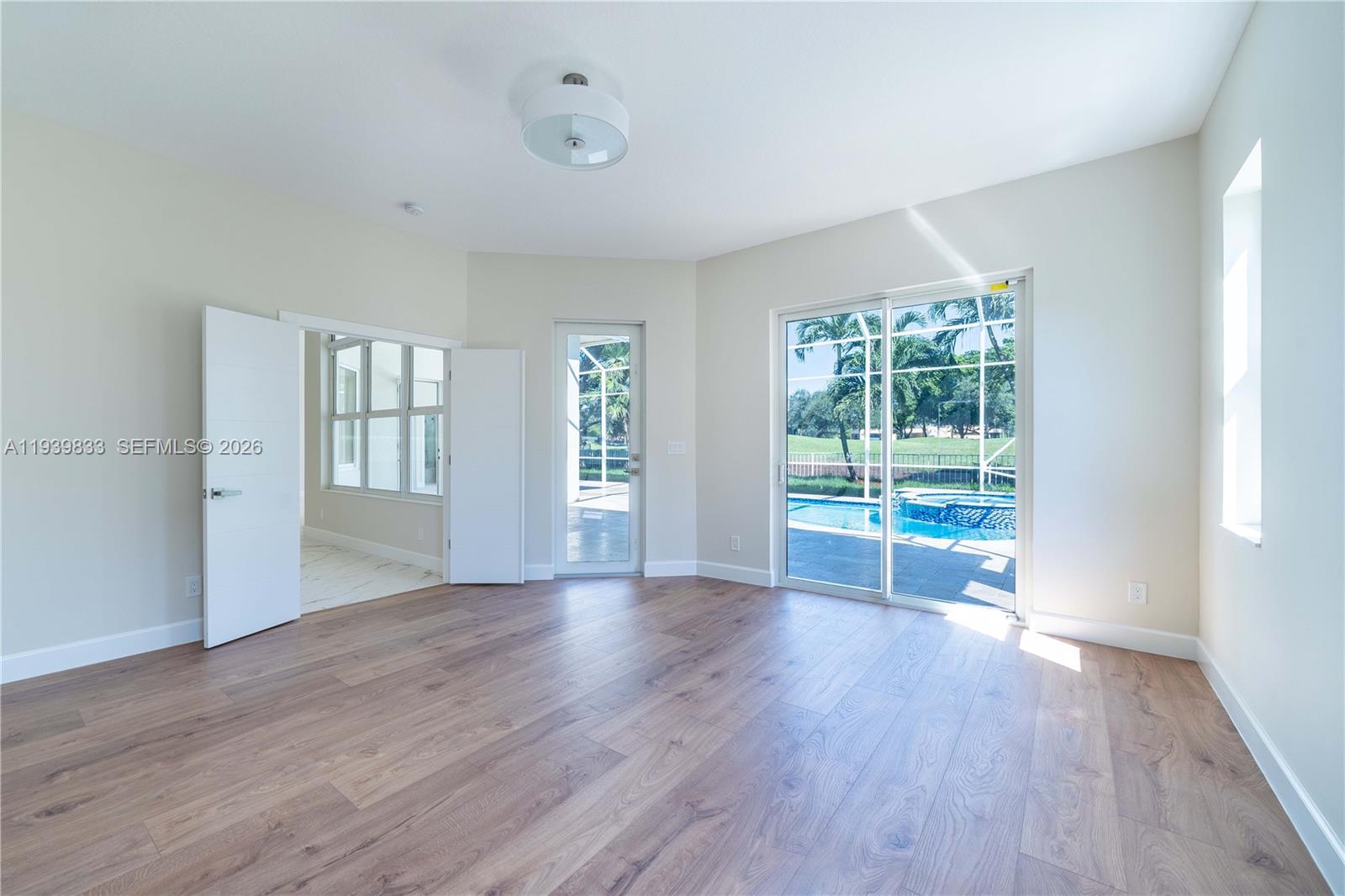 8041 Bermuda Point Lane Davie, FL 33328 - Photo 34 of 60 an empty room with wooden floor and windows
