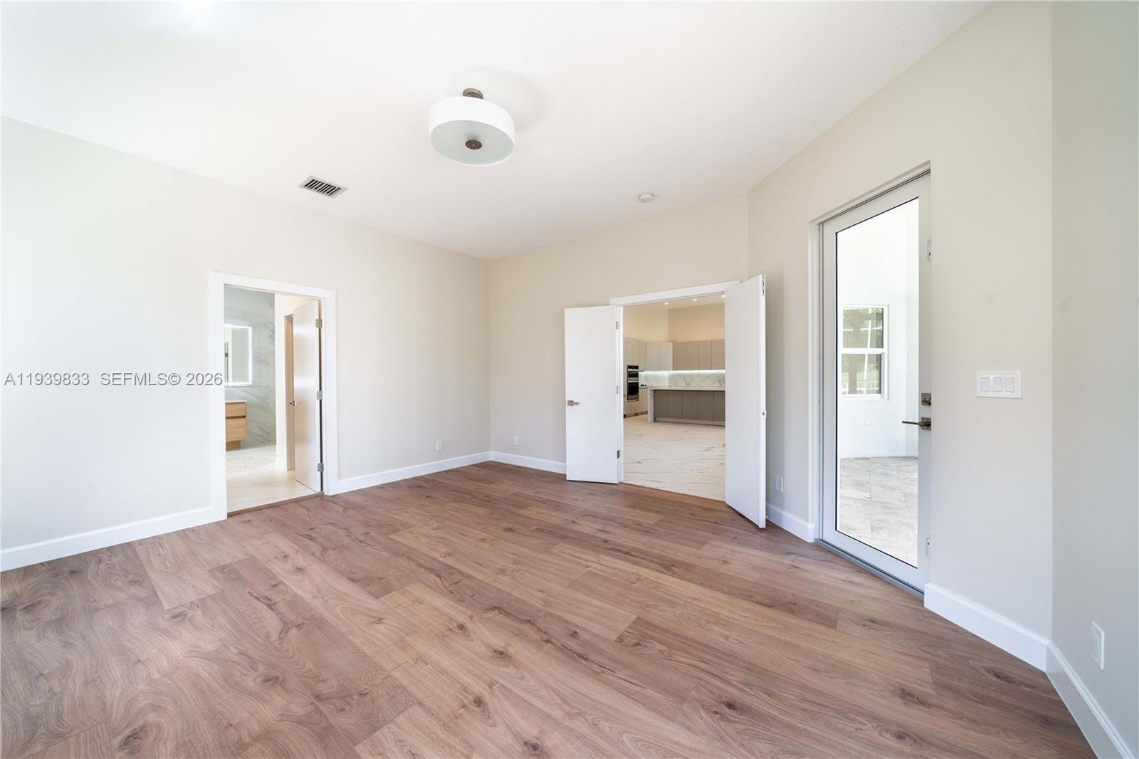 8041 Bermuda Point Lane Davie, FL 33328 - Photo 36 of 60 a view of empty room with wooden floor