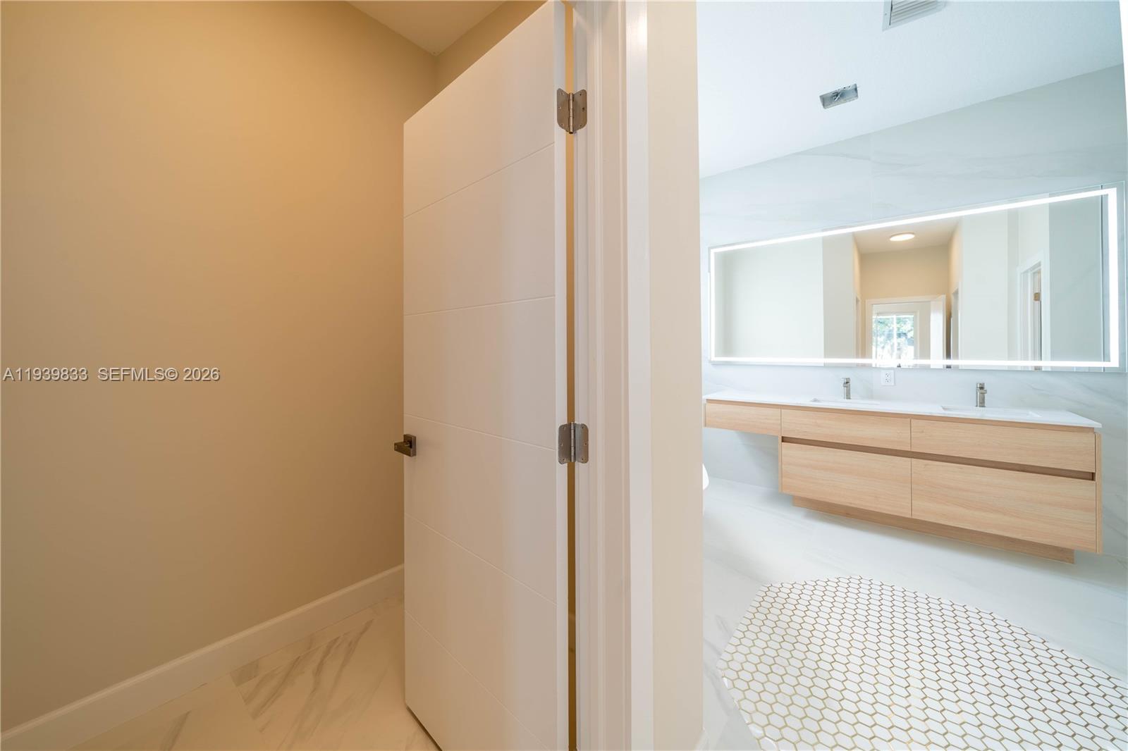 8041 Bermuda Point Lane Davie, FL 33328 - Photo 37 of 60 a bathroom with a sink and a mirror