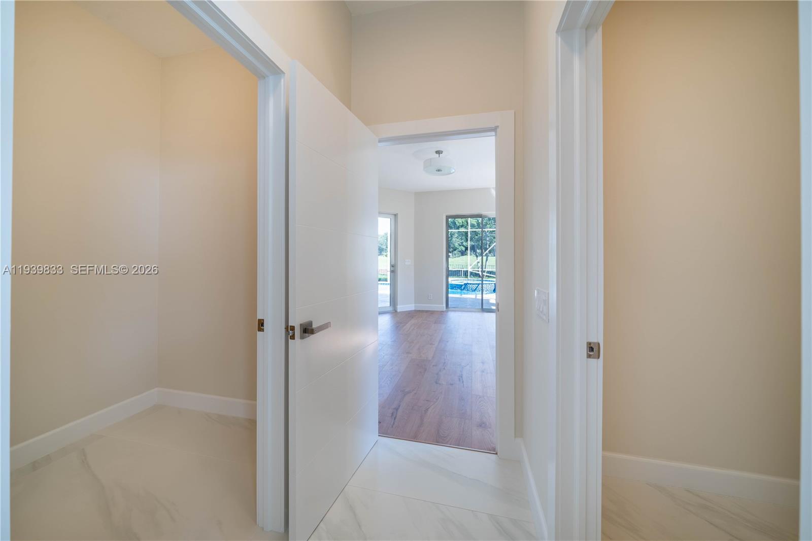 8041 Bermuda Point Lane Davie, FL 33328 - Photo 38 of 60 a view of a hallway with wooden floor