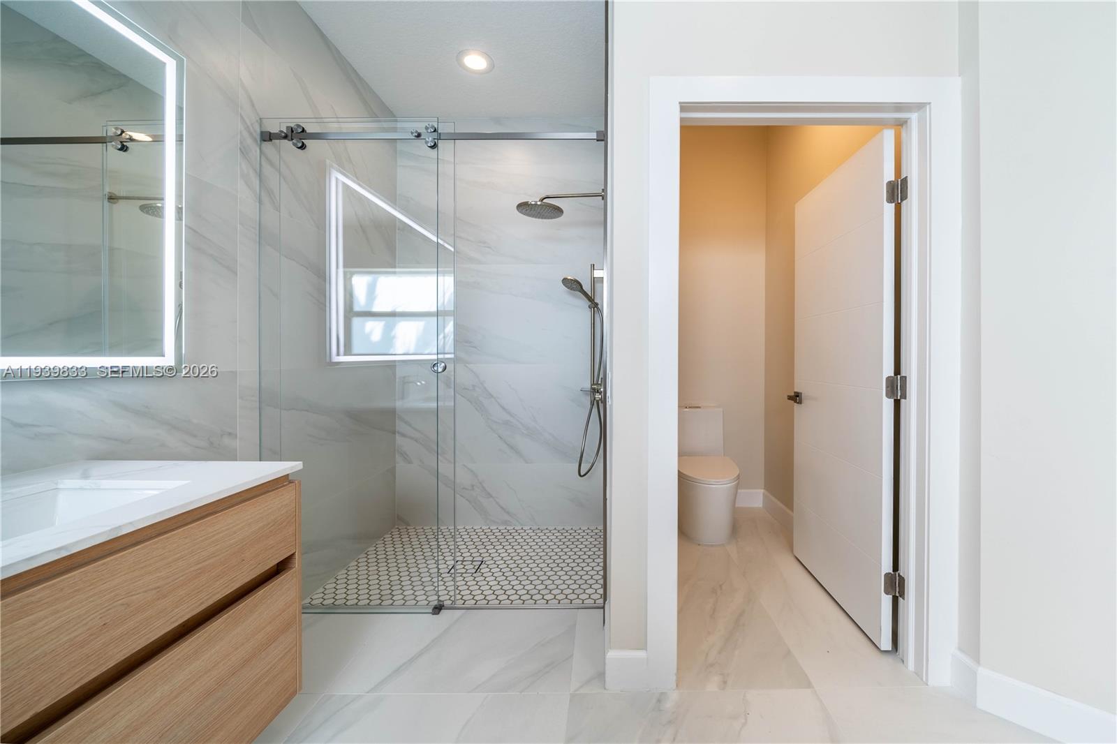 8041 Bermuda Point Lane Davie, FL 33328 - Photo 41 of 60 a bathroom with a shower and a sink