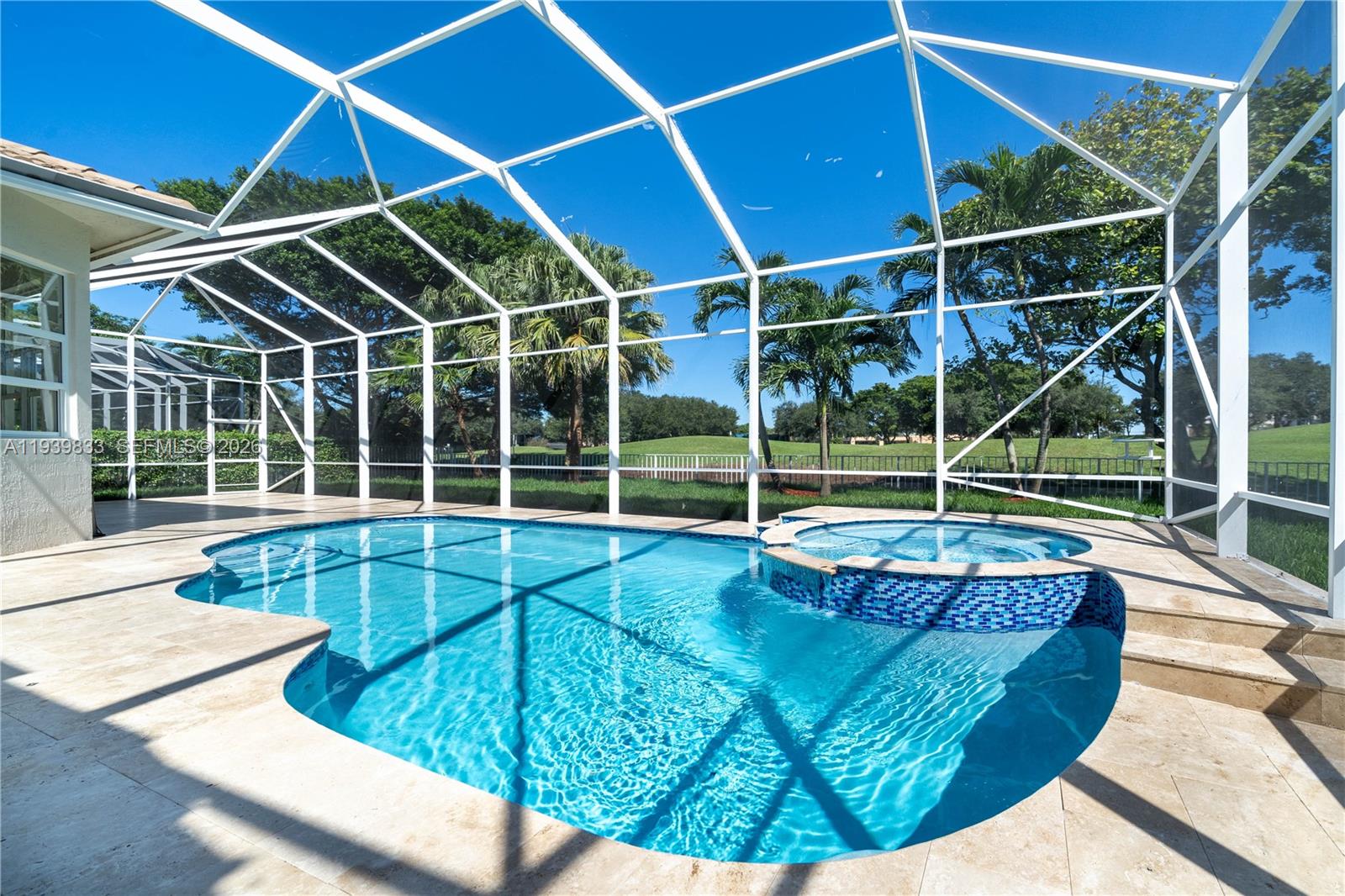 8041 Bermuda Point Lane Davie, FL 33328 - Photo 50 of 60 a view of a backyard with a swimming pool