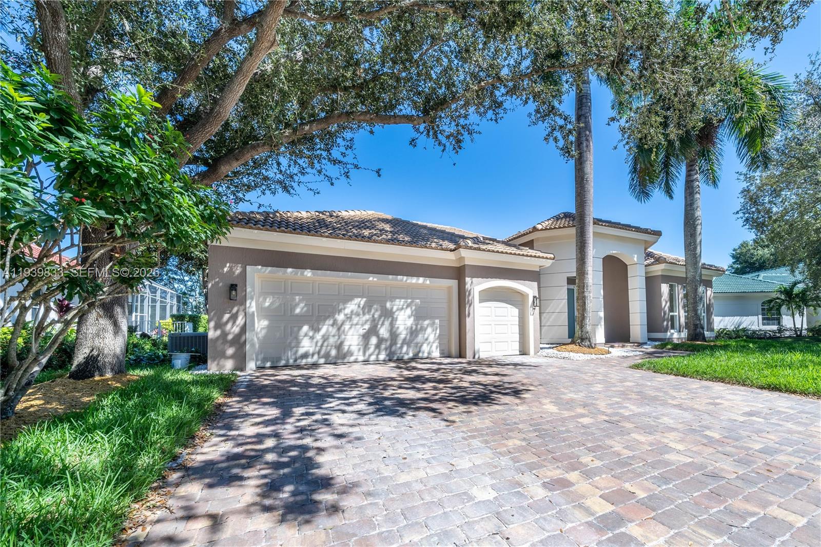 8041 Bermuda Point Lane Davie, FL 33328 - Photo 5 of 60 a front view of a house with a garden and yard