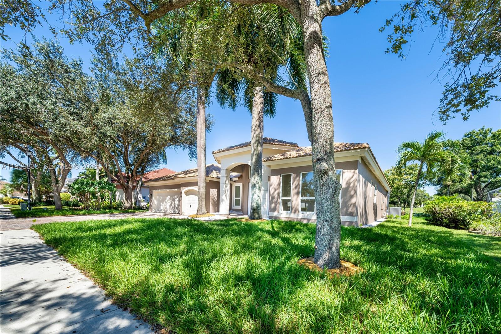 8041 Bermuda Point Lane Davie, FL 33328 - Photo 8 of 60 a front view of a house with garden