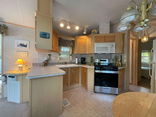 a kitchen with stainless steel appliances granite countertop a sink and a stove