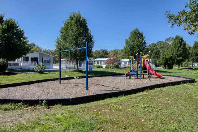 a view of a swimming pool with a yard and sitting area