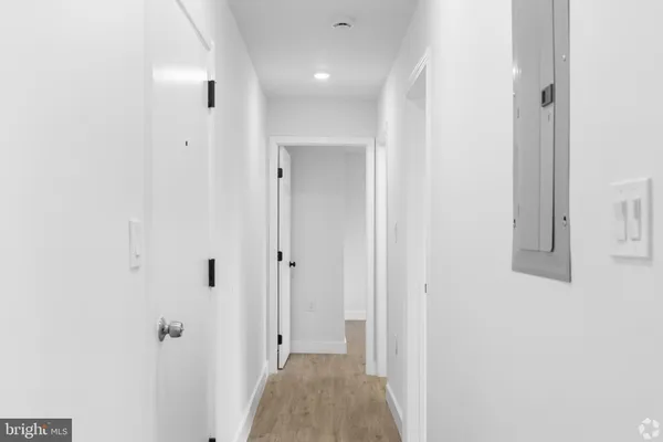 a view of a hallway with closet and bathroom