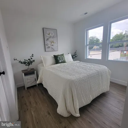 a bedroom with a bed and a large window