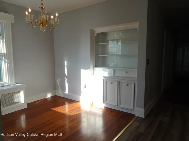 a view of a room with wooden floor and staircase