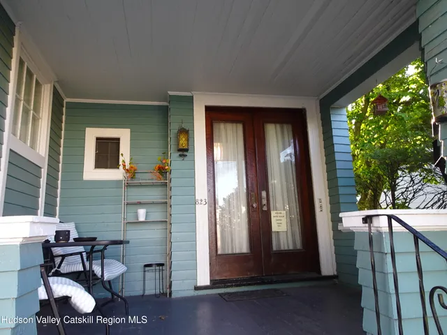 a view of a porch with a chairs and table in a patio
