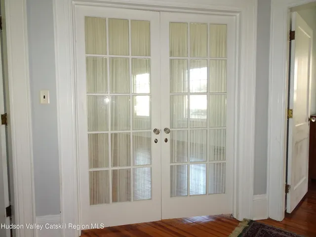 a view of wooden floor and windows in a room