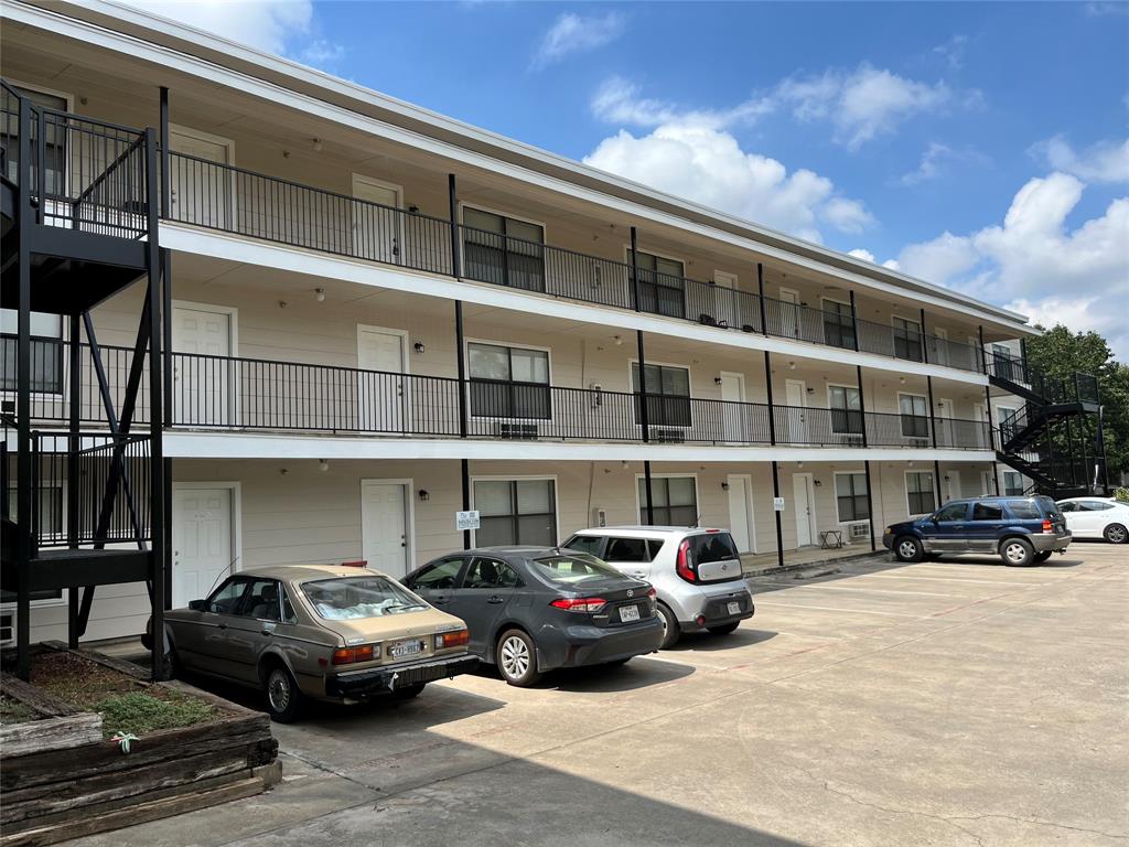 701 West Sycamore Street, Unit 104 Denton, TX 76201 - Photo 9 of 10 Wide-angle exterior shot highlighting the building's multi-level layout and clean facade.