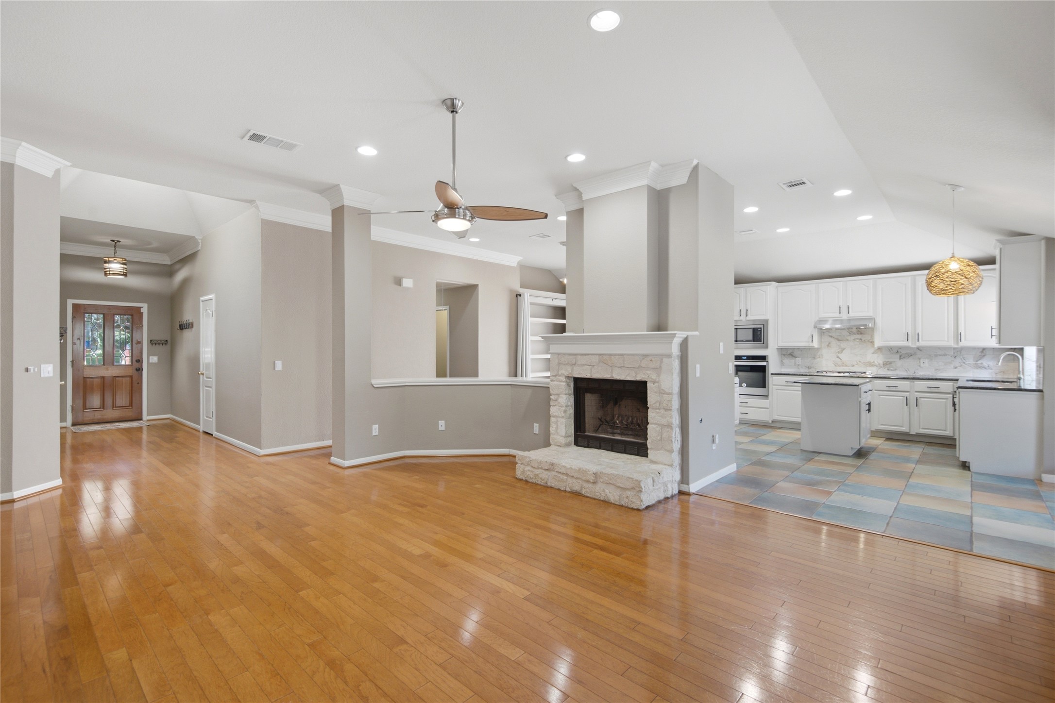 6032 Roxbury Lane Austin, TX 78739 - Photo 34 of 34 Warm hardwood flooring and a stone fireplace anchor this flowing open floor plan.
