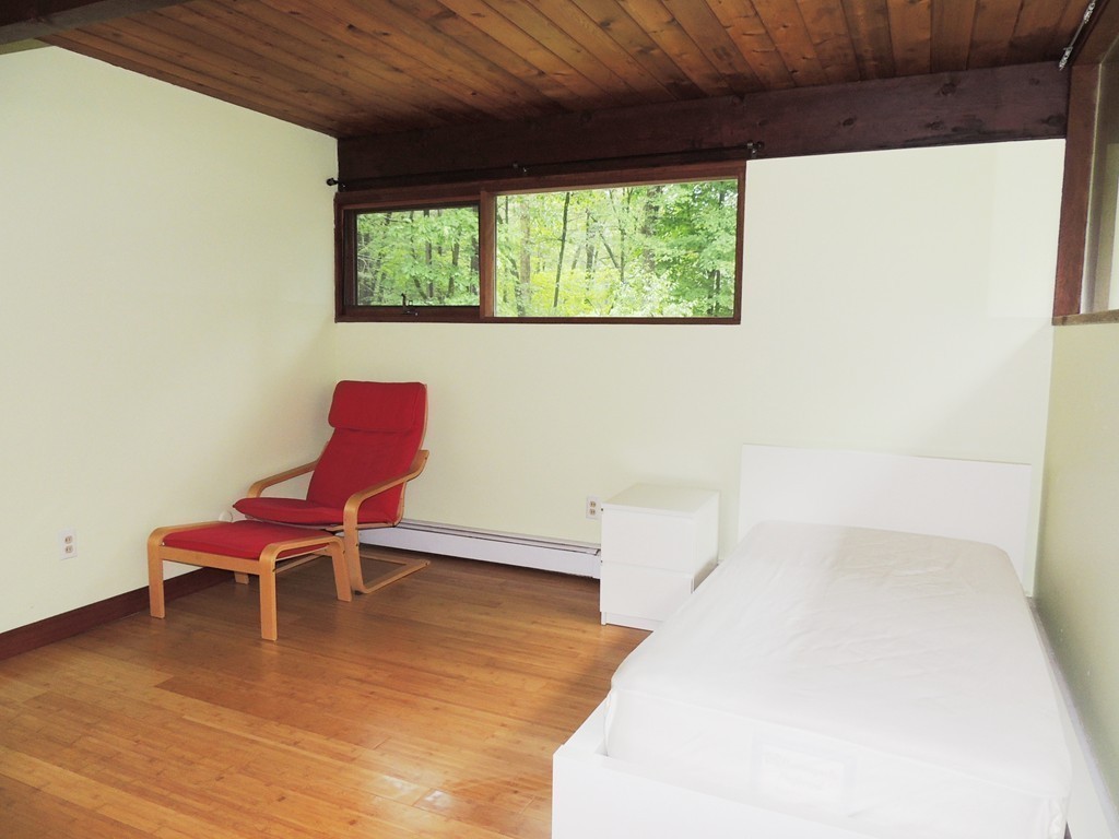 76 Wolf Rock Road Carlisle, MA 01741 - Photo 11 of 20 a chair and a table in a room