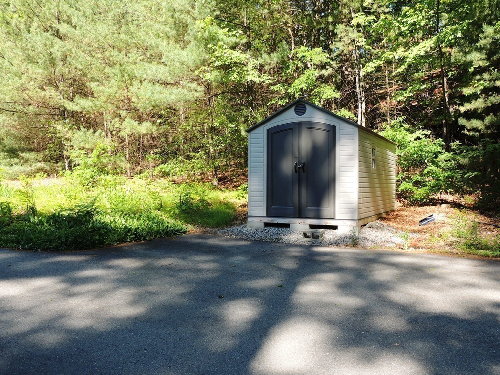 76 Wolf Rock Road Carlisle, MA 01741 - Photo 16 of 20 a view of a wooden door and a yard
