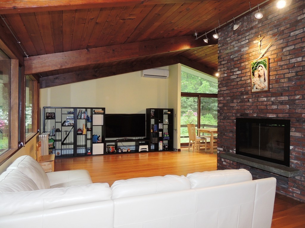 76 Wolf Rock Road Carlisle, MA 01741 - Photo 3 of 20 a living room with furniture a flat screen tv and a fireplace