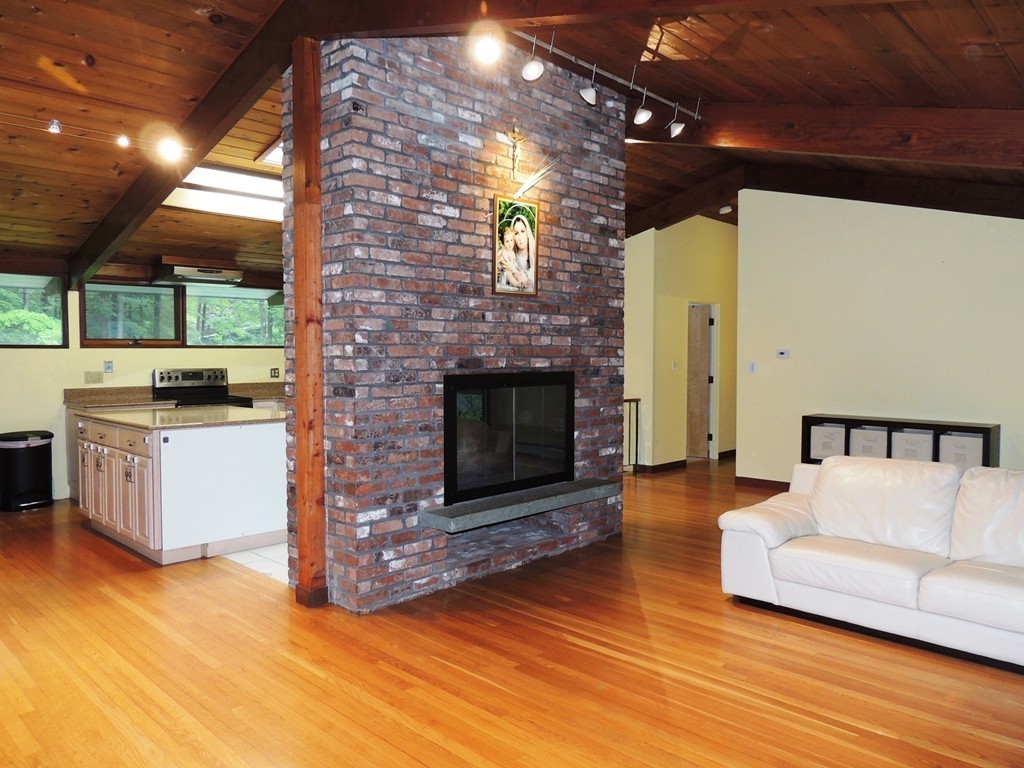 76 Wolf Rock Road Carlisle, MA 01741 - Photo 4 of 20 a living room with furniture and a fireplace