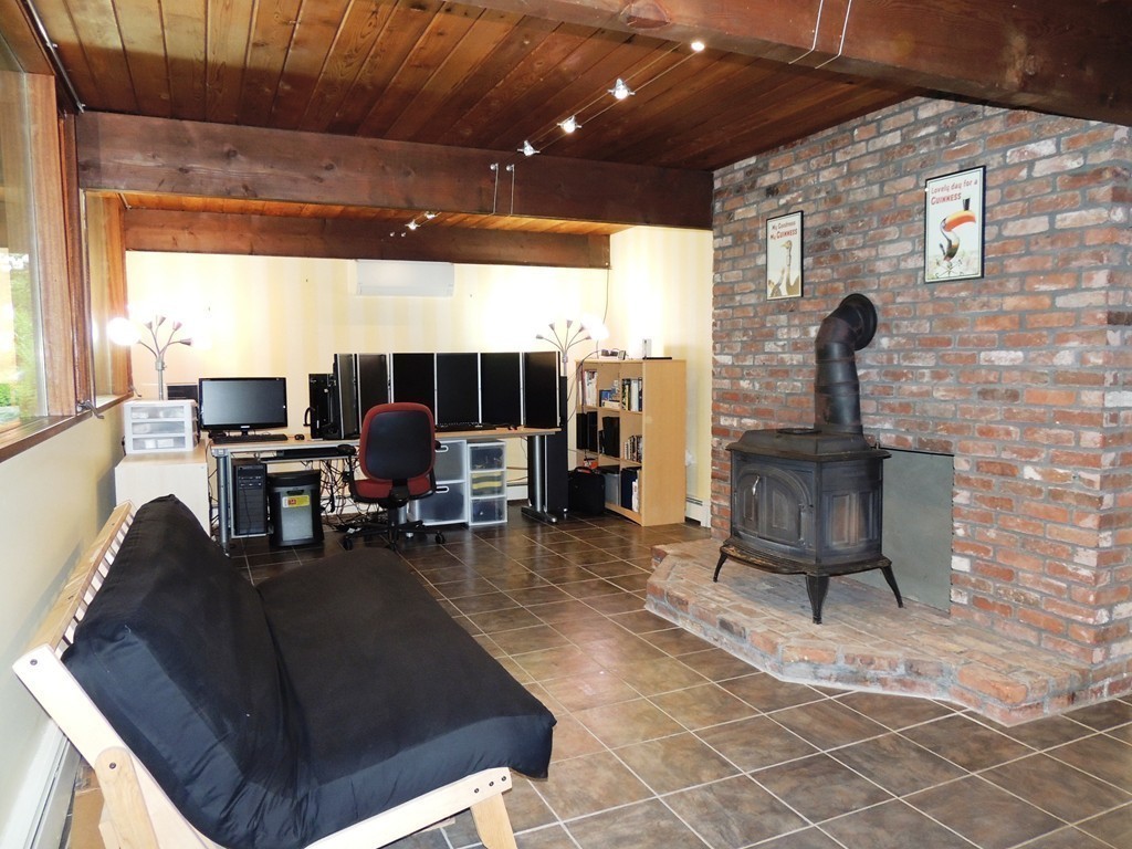 76 Wolf Rock Road Carlisle, MA 01741 - Photo 8 of 20 a living room with couches and a flat screen tv