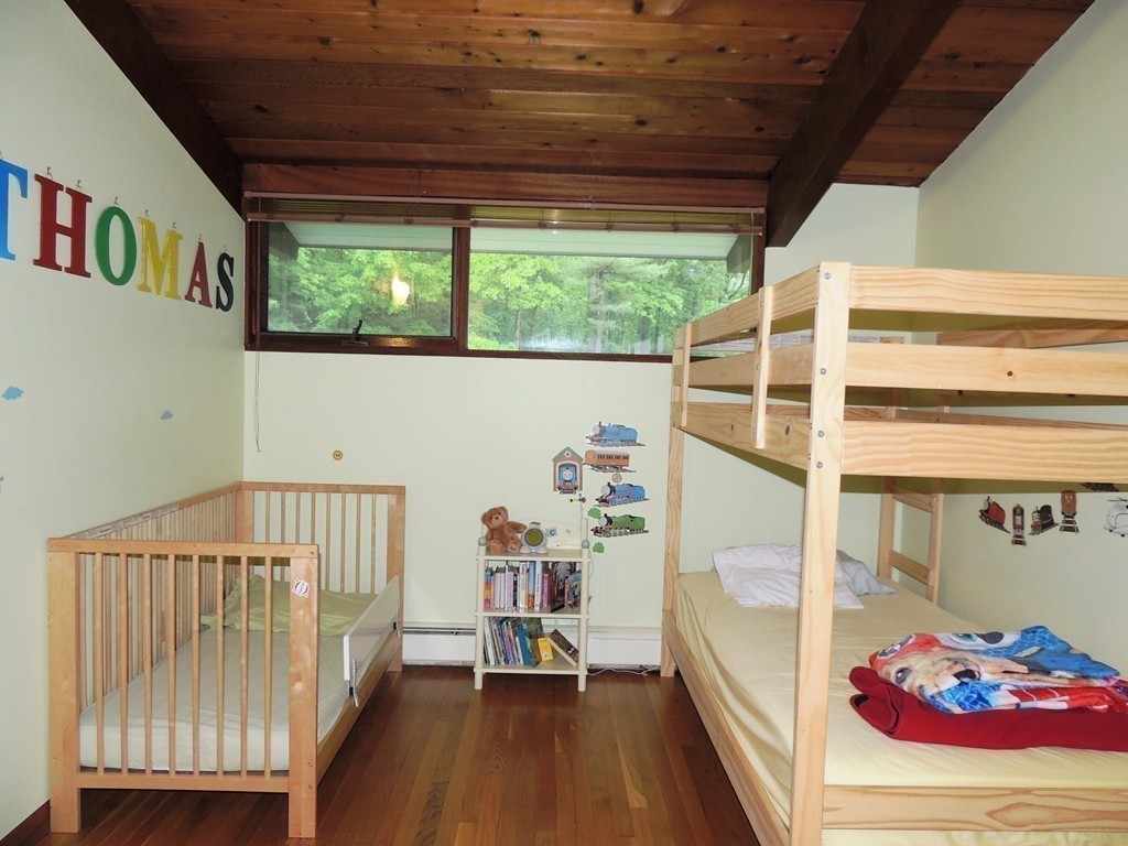 76 Wolf Rock Road Carlisle, MA 01741 - Photo 10 of 20 a view of a bedroom with baby crib and a window