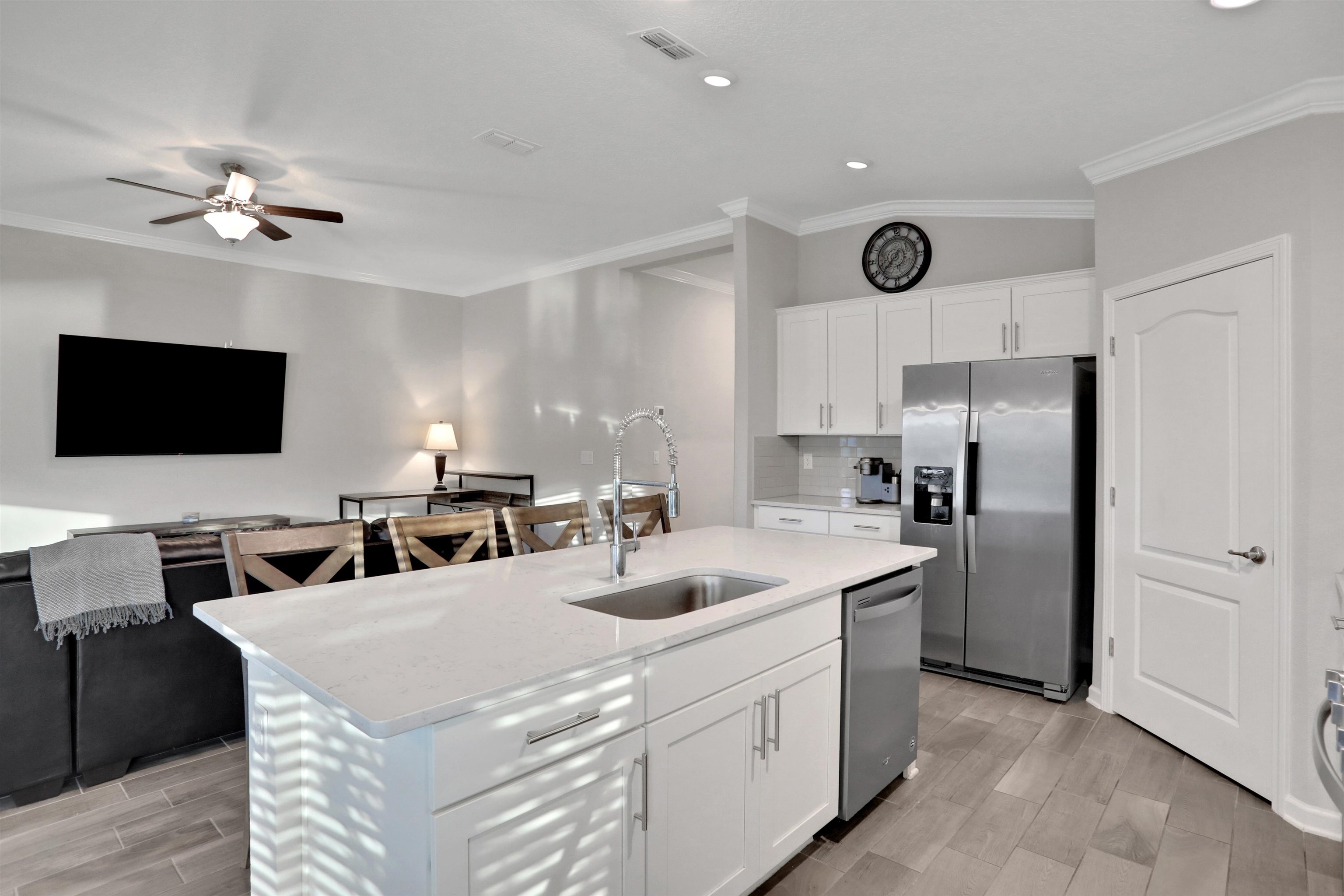 Undisclosed Address St. Augustine, FL 32095 - Photo 51 of 51 Kitchen with open floor plan, white cabinets, appliances with stainless steel finishes, wood tiled floors, and crown molding