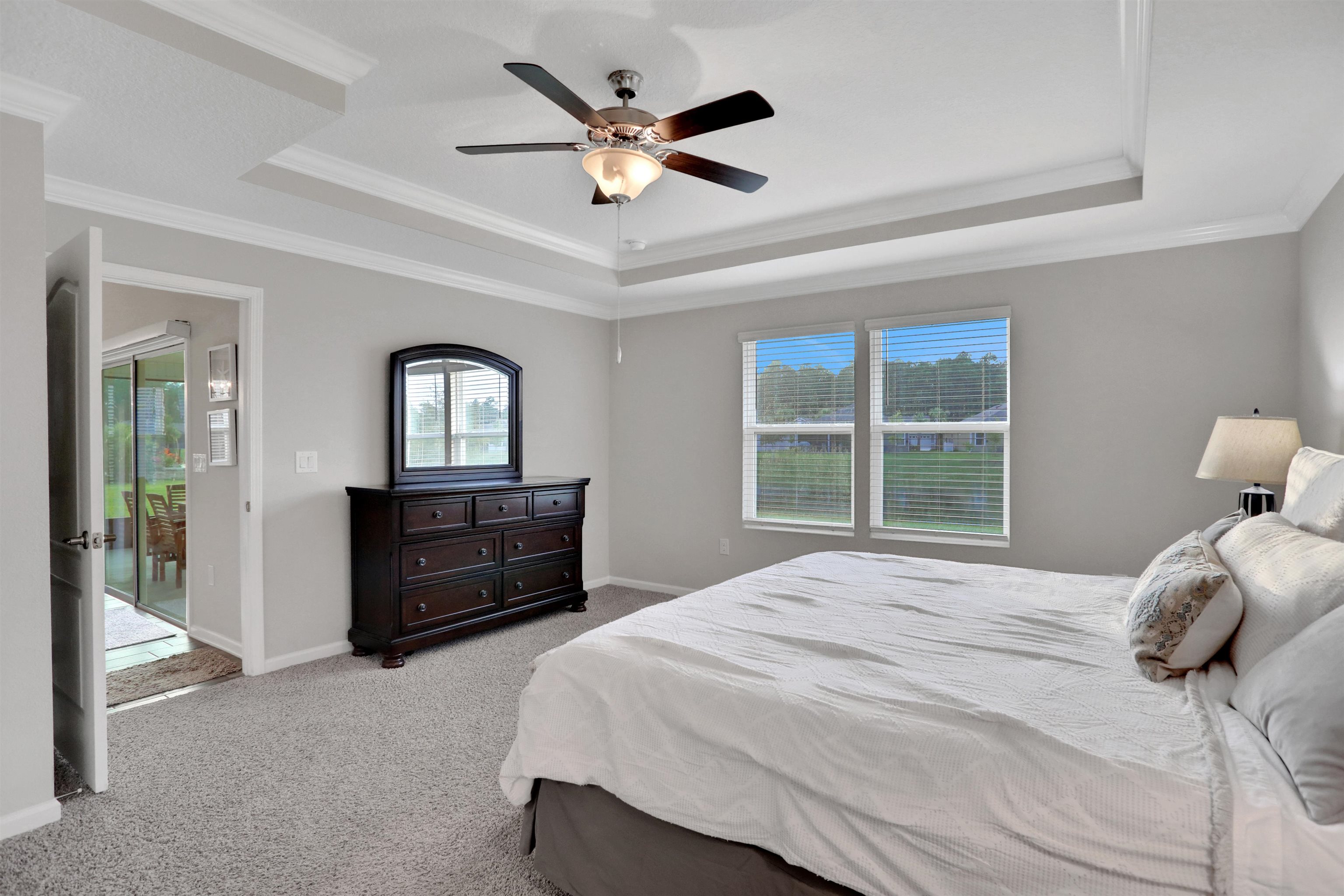 Undisclosed Address St. Augustine, FL 32095 - Photo 27 of 51 a bedroom with a bed and a large window with a chandelier