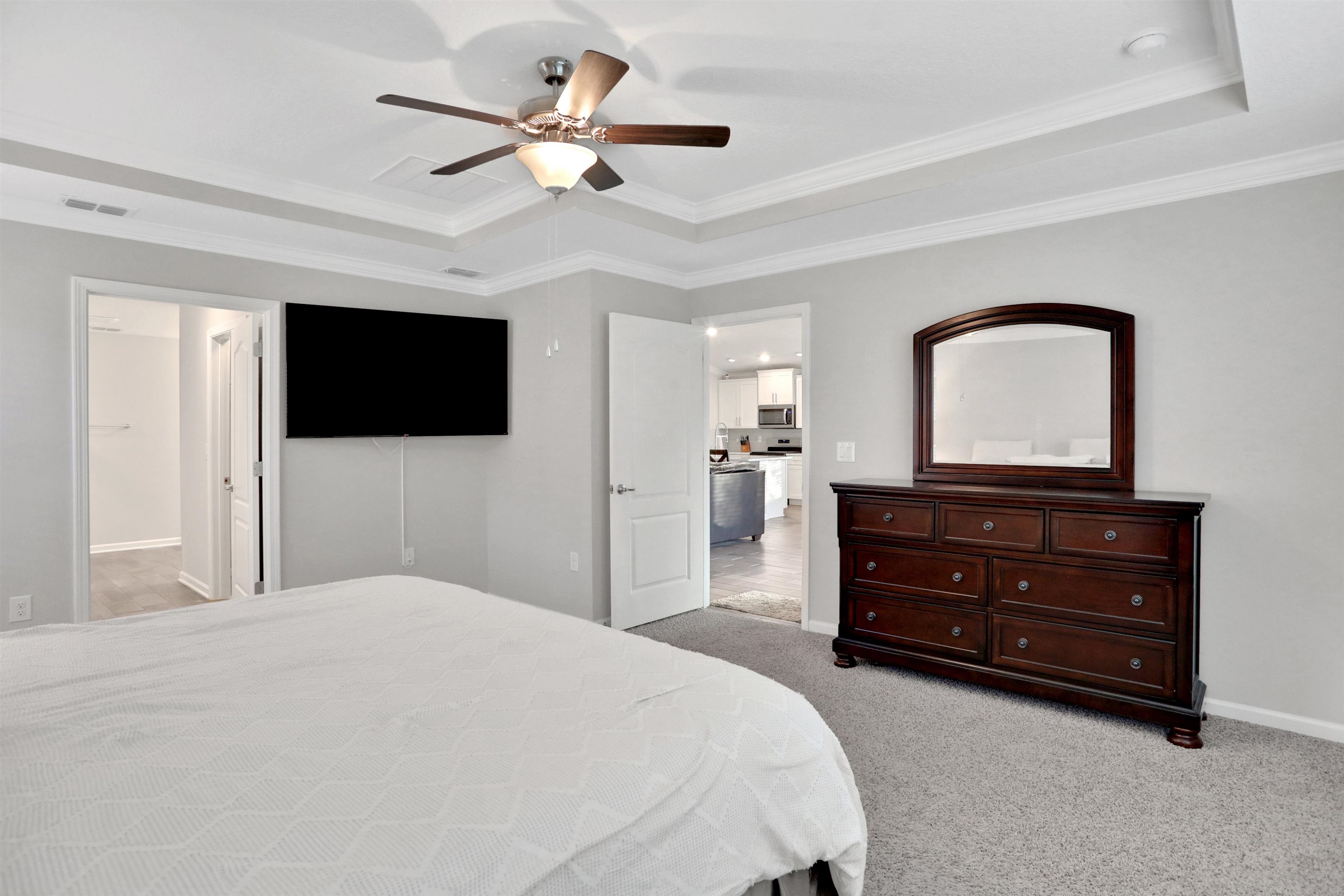 Undisclosed Address St. Augustine, FL 32095 - Photo 31 of 51 a bedroom with a bed a mirror and a flat tv screen on dresser