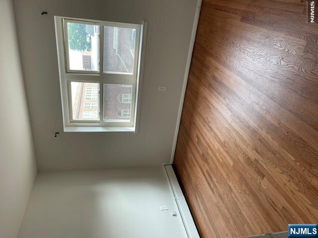 279 Chestnut Street Nutley, NJ 07110 - Photo 9 of 9 an empty room with wooden floor and windows