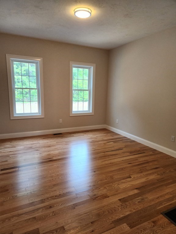 81 Purgatory Road Sutton, MA 01590 - Photo 12 of 35 an empty room with wooden floor and windows