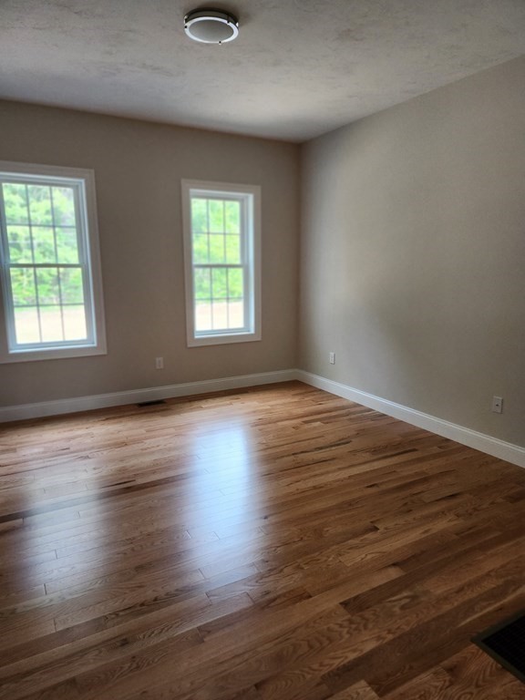 81 Purgatory Road Sutton, MA 01590 - Photo 13 of 35 an empty room with wooden floor and windows