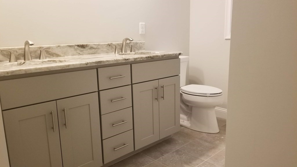 81 Purgatory Road Sutton, MA 01590 - Photo 15 of 35 a bathroom with a granite countertop sink and a toilet