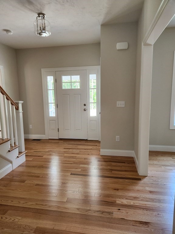 81 Purgatory Road Sutton, MA 01590 - Photo 21 of 35 a view of an empty room with wooden floor and a window