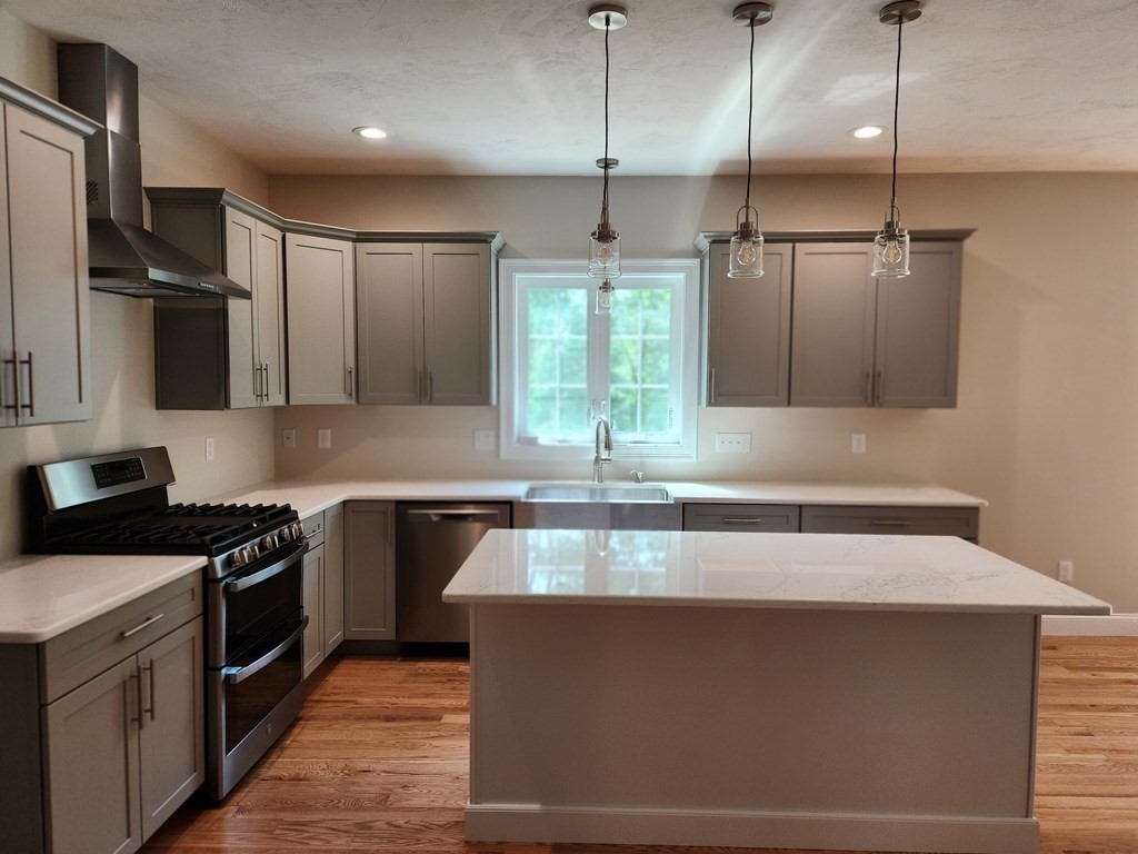 81 Purgatory Road Sutton, MA 01590 - Photo 5 of 35 a kitchen with stainless steel appliances granite countertop a sink a stove and a refrigerator