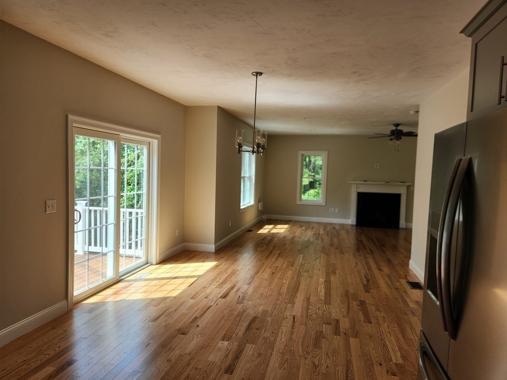 81 Purgatory Road Sutton, MA 01590 - Photo 7 of 35 a view of a kitchen with wooden floor and a refrigerator