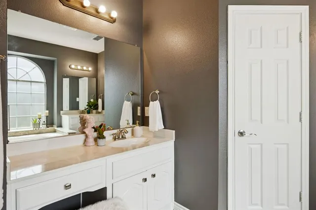 a bathroom with a double vanity sink and a mirror
