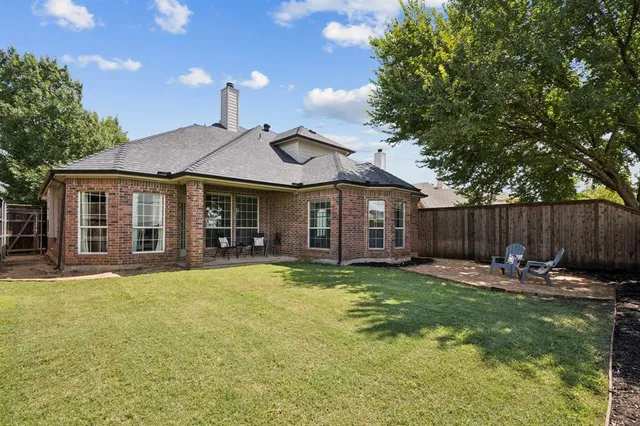 a view of a chair and table in backyard