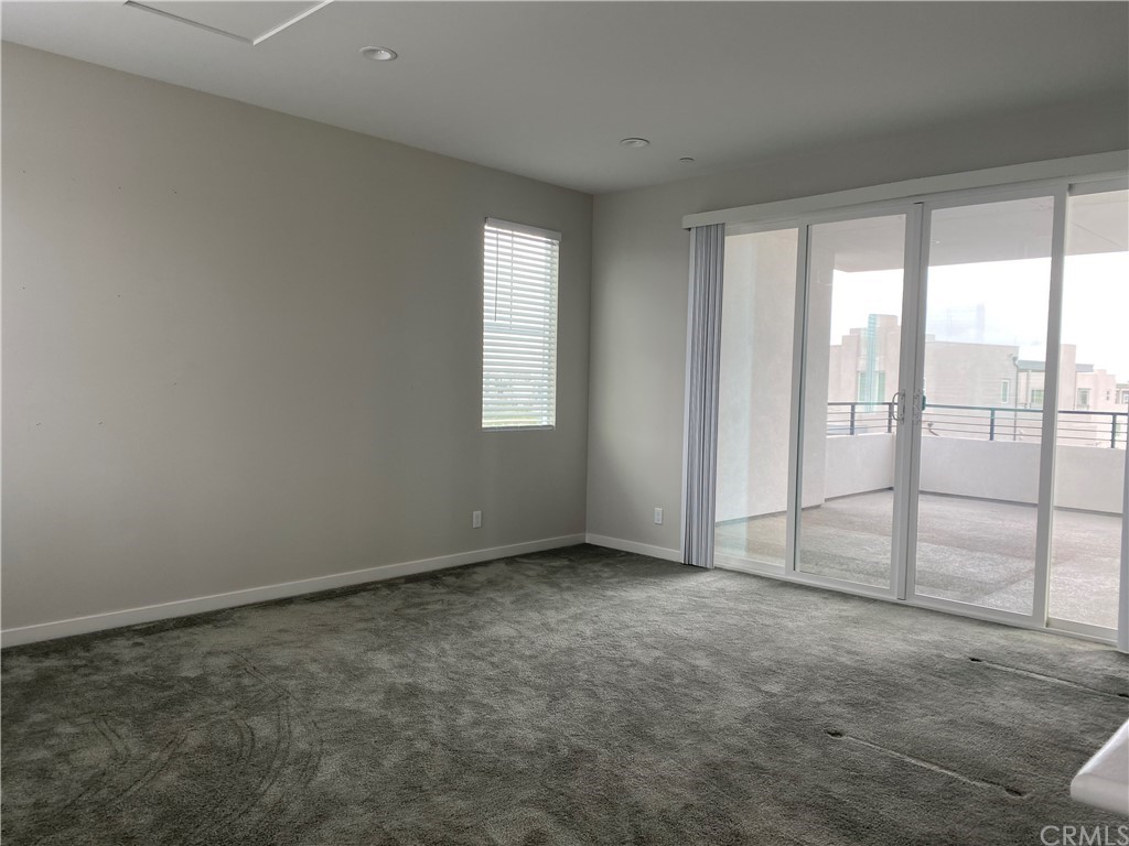 163 Stage Irvine, CA 92618 - Photo 11 of 18 an empty room with a empty space and sliding door
