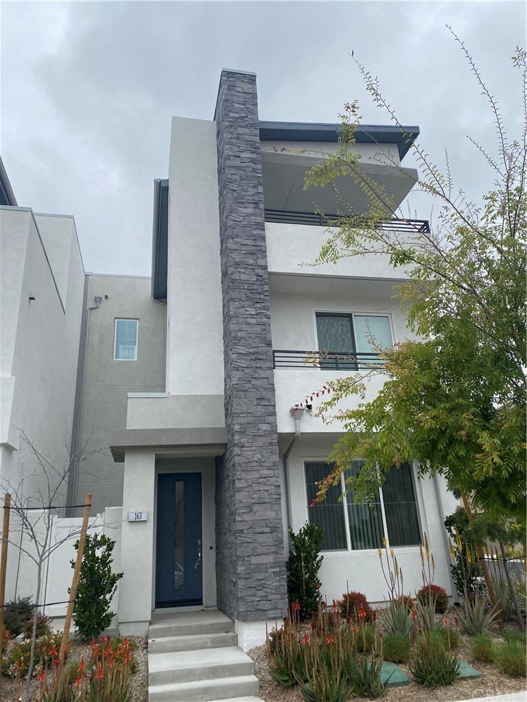 163 Stage Irvine, CA 92618 - Photo 2 of 18 a front view of a house with a yard