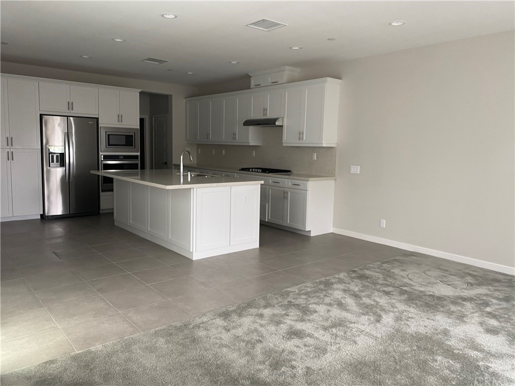 163 Stage Irvine, CA 92618 - Photo 4 of 18 a large kitchen with cabinets and stainless steel appliances