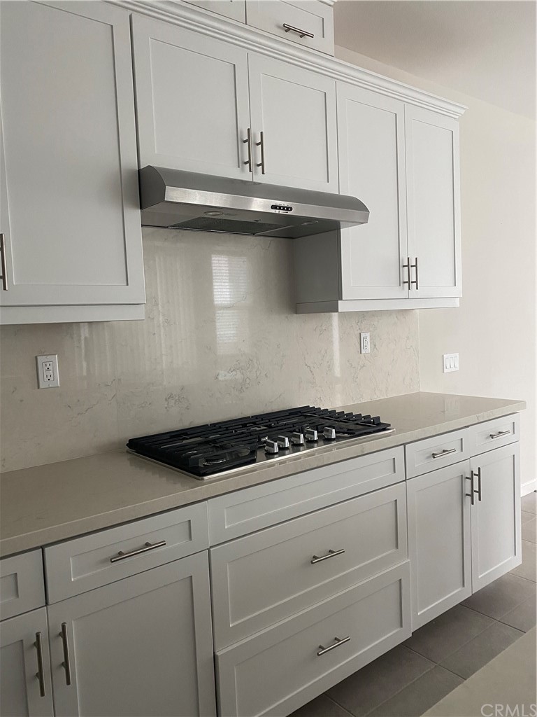 163 Stage Irvine, CA 92618 - Photo 6 of 18 a kitchen with white cabinets and appliances