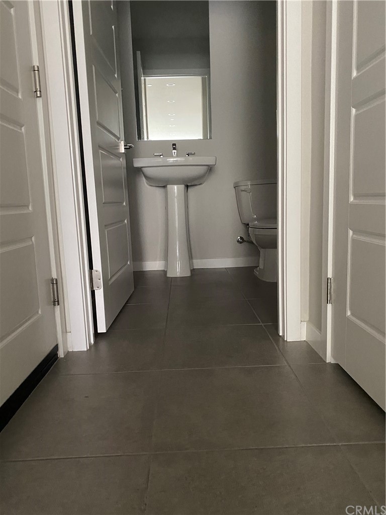 163 Stage Irvine, CA 92618 - Photo 8 of 18 a view of hallway with sink and mirror