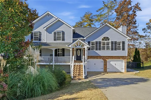 a front view of a house with a yard and garage