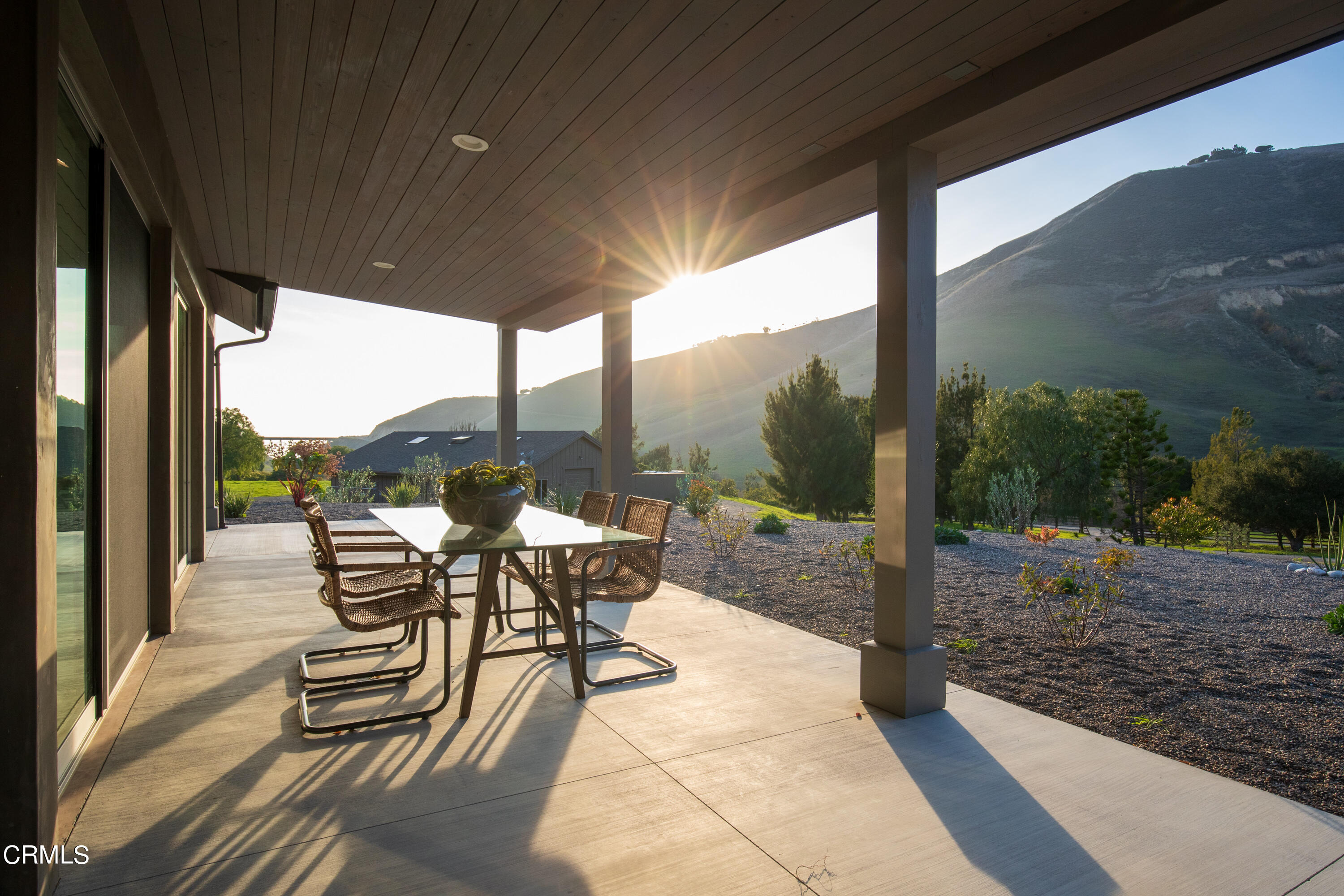 119 Hollister Ranch Road Goleta, CA 93117 - Photo 17 of 40 a view of a patio with chairs and floor to ceiling window