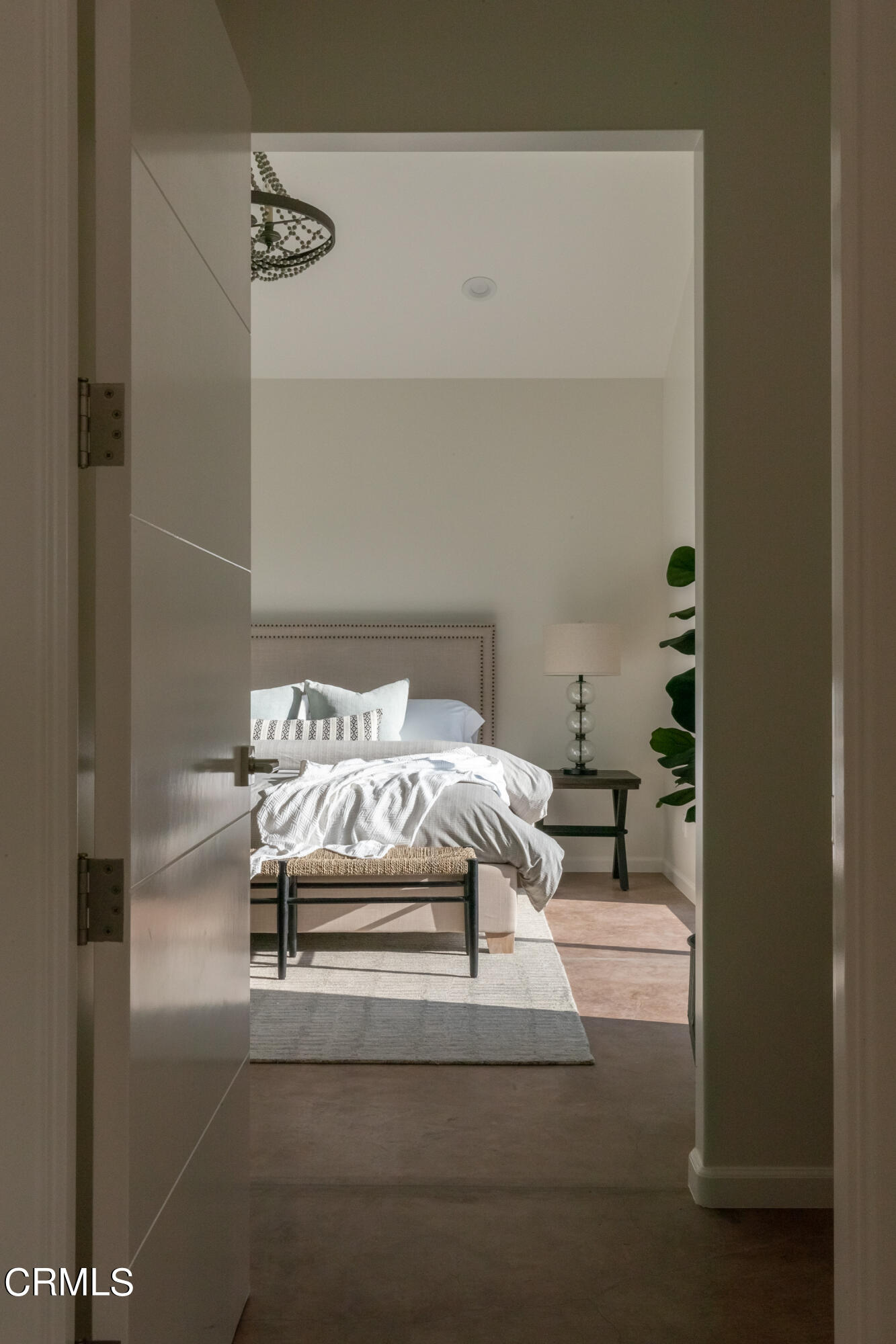 119 Hollister Ranch Road Goleta, CA 93117 - Photo 9 of 40 a bed sitting in a bedroom next to a bathroom with a sink and a mirror